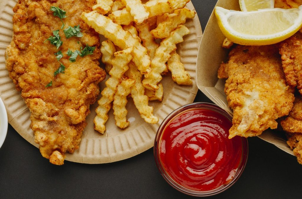 top-view-fish-chips-with-selection-sauces-cutlery
