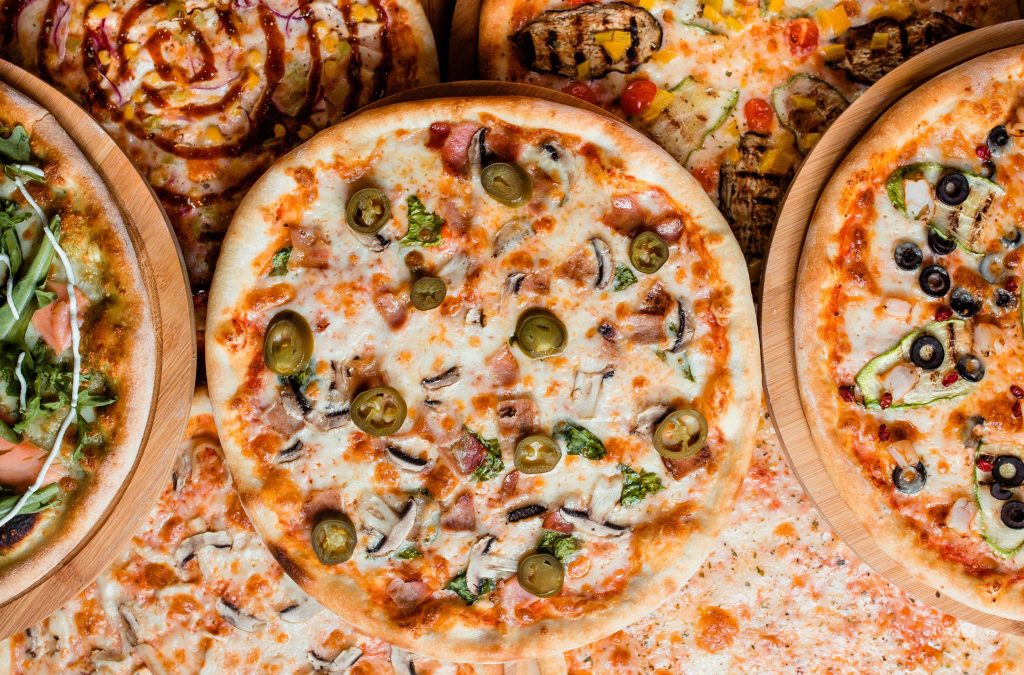 various pizzas on the table top view